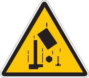 A caution sign depicting falling construction tools, warning of the risk of injury