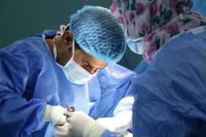 A surgeon works with an assistant while performing gastric bypass surgery