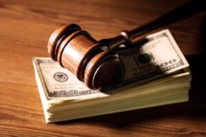 A gavel atop a stack of money from a Nexium lawsuit settlement