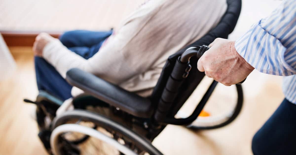 A woman in a wheelchair who had a stroke as one of the Lemtrada side effects