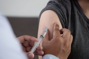 A patient receiving a vaccination similar to the Location Vaccination inoculations that resulted in their shutdown.