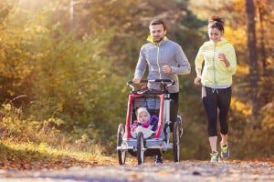 A young family jogging with a stroller similar to the one target by the CPSC in their recent BOB stroller recall lawsuit.