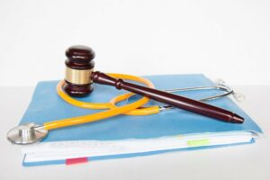 a gavel and stethoscope sit on top of a proton pump lawsuit file